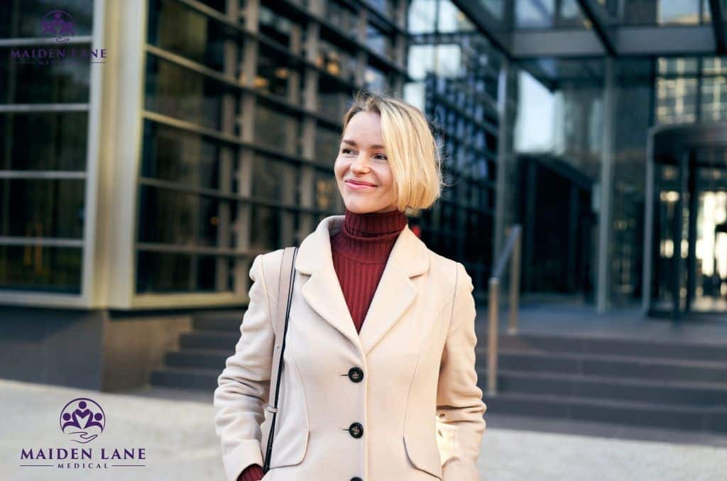 A business woman in NYC outside and smiling.