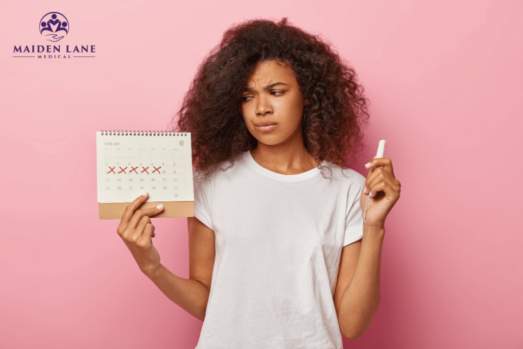 A woman holding a calendar and tampon wondering about when her period is coming in New York, Manhattan.