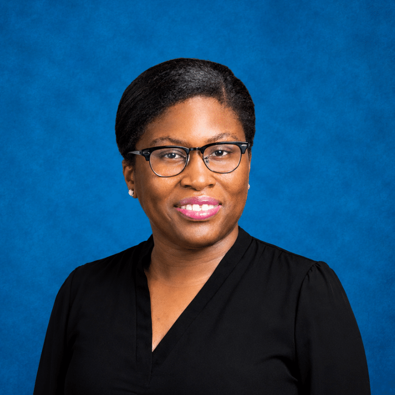 Headshot of Alexandra Fleary with blue background