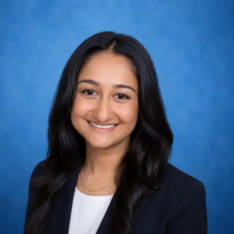 Headshot of Anindita Varshneya, MD with blue background