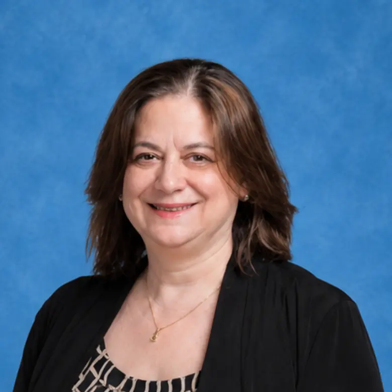 Headshot of Dena Harris, MD with blue background