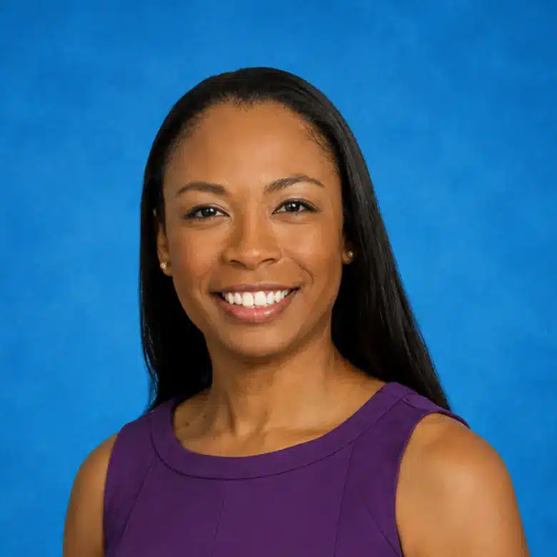 Headshot of Emily Blanton, MD with blue background