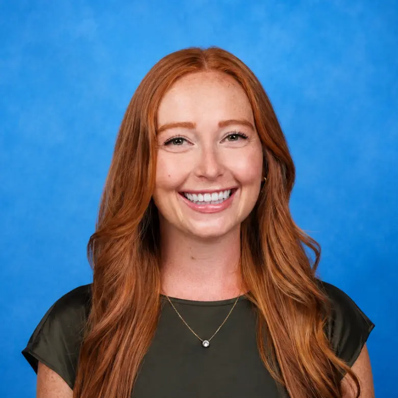 Headshot of Emily Eischen, MD with blue background