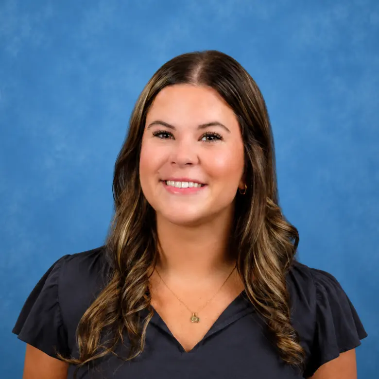 Headshot of Emma Izzo, PA-C with blue background