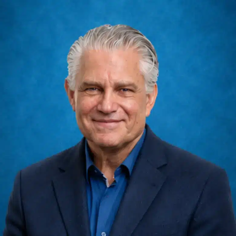 Headshot of Eric M. Wahl, MD with blue background
