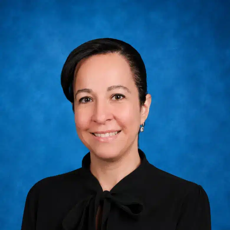 Headshot of Flavia Theil, MD with blue background
