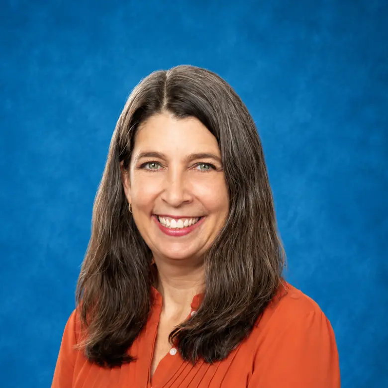 Headshot of Gillian Scott Hans, NP, CNM with blue background
