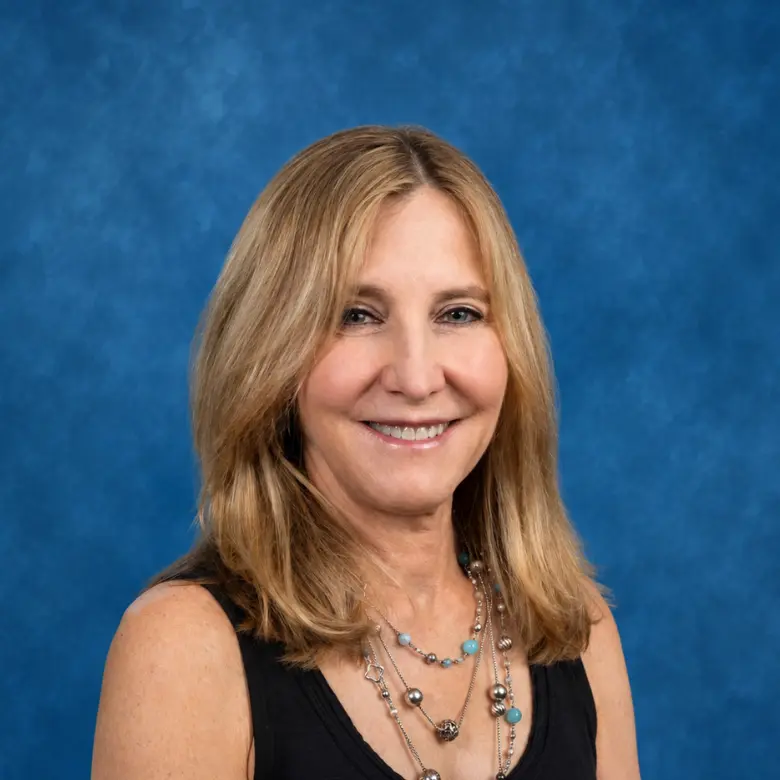 Headshot of Ilene Fischer, MD with blue background