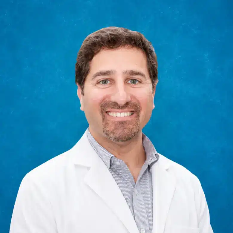 Headshot of Jay Matut MD, FACOG with blue background