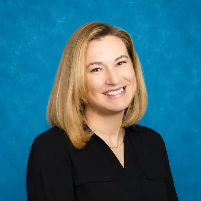 Headshot of Jill-Ann Swenson, MD, FACOG with blue background