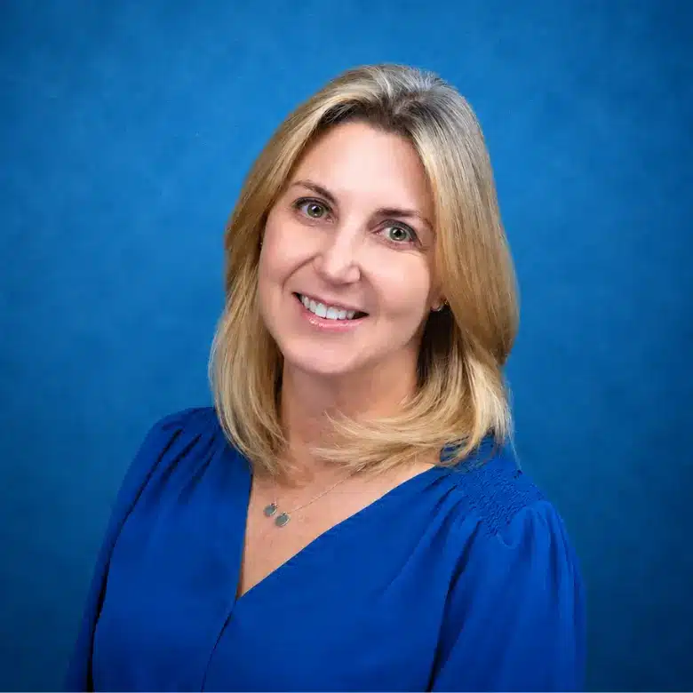 Headshot of Marla Abramson, MD with blue background