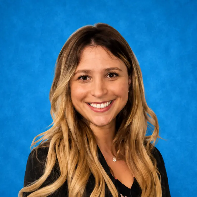 Headshot of Natalie Mandel, MD, MPH with blue background