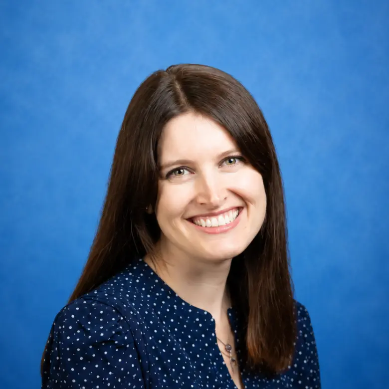 Headshot of Rachel Barr, MD with blue background
