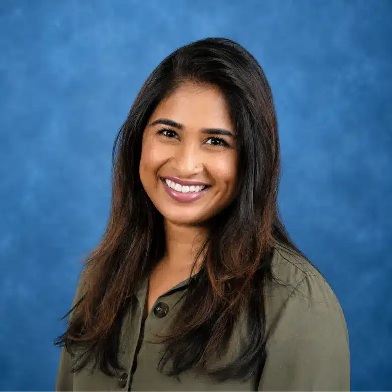 Headshot of Sanika Gadkari, MD with blue background