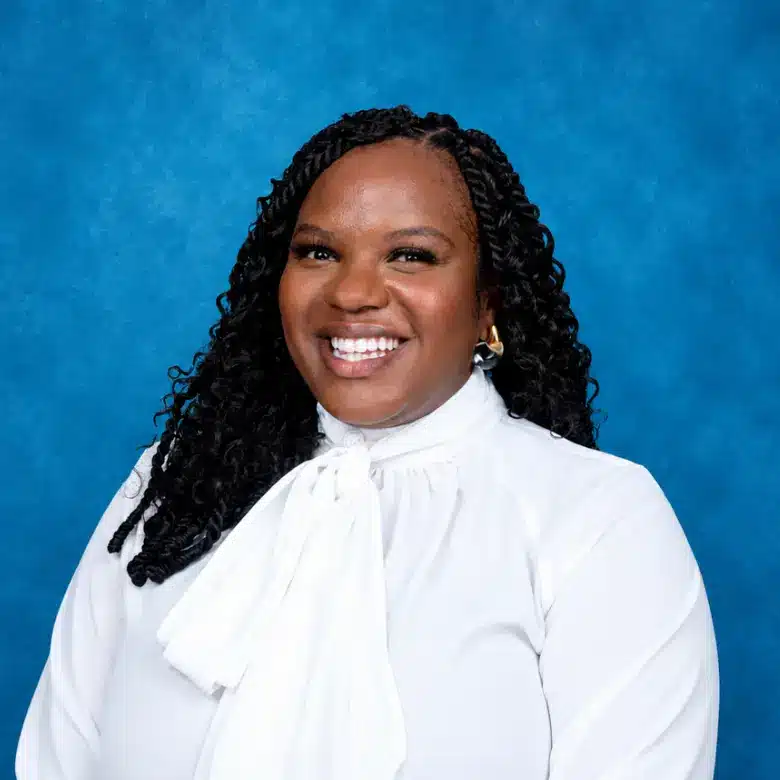 Headshot of Terri-Ann Nelson, MD with blue background