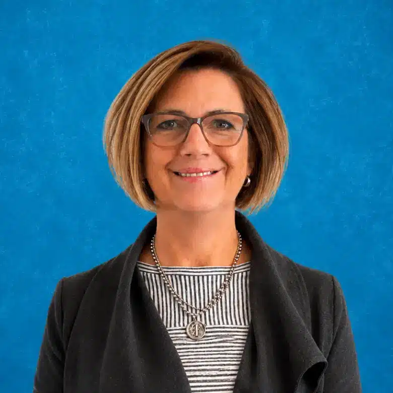 Headshot of Tiffani Hughson with blue background