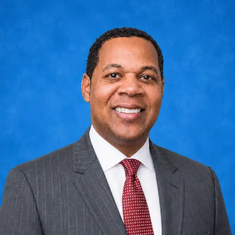 Headshot of Dr. Erik Smith with blue background