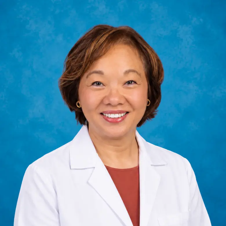 Headshot of Dr. Kwon with blue background